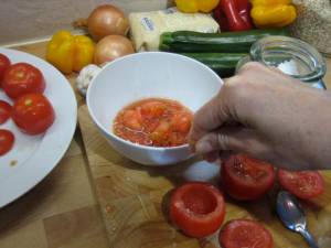 Scooping out the inside of tomatoes 